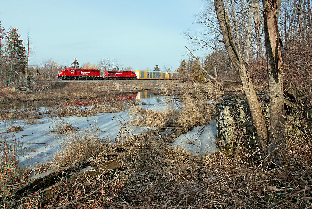 It's a slow climb up Campbellville Hill and both units are nearing the top of the grade with 110 cars on the drawbar. Seen here, the sun makes an appearance on this rather warm Sunday afternoon as the head end passes by capturing a broadside of two somewhat clean units.