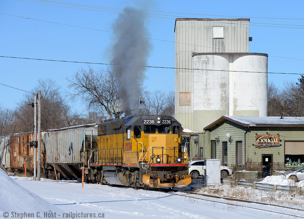 Smoking it up, GEXR 518 is passing a former Grain Elevator near downtown Kitchener - surprisingly the facility is now a bakery. Behind the elevator was the former CPR owned Grand River Railway which shared the Huron Park Spur as joint track from just behind me to South Junction from 1961 to 1994 after which the GRR north of here was abandoned.  The ex CNR spur is all that remains in downtown Kitchener.