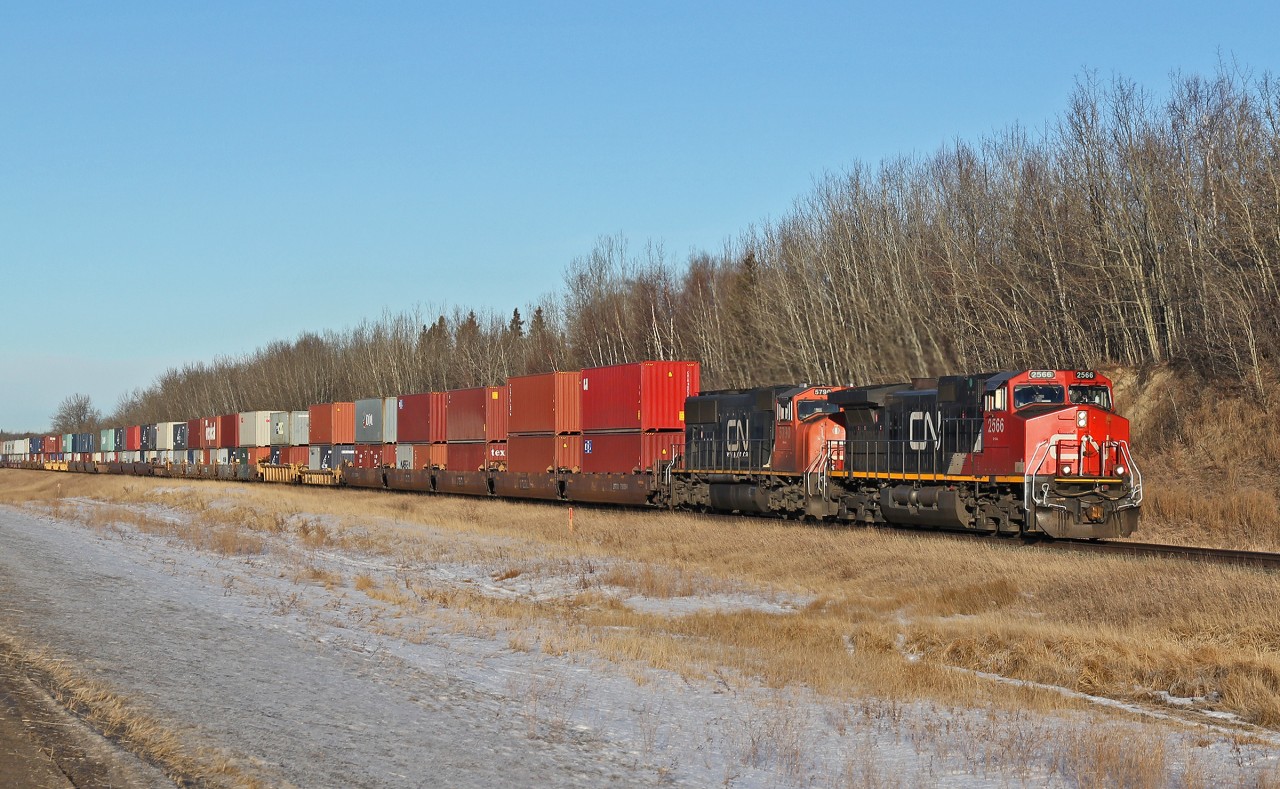 Dash 9-44CW CN 2566 and SD75I CN 5790 head east past North Cooking Lake.
