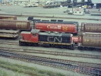 CN 1003 was the last CN locomotive used on Vancouver Island. In this 1988 photograph the CN locomotive was sitting in the CP water front yards at Vancouver BC. She had just completed her last ferry ride between Vancouver Island and the lower mainland. Soon she will be off to the CN shops in Port Mann. Glad I took my camera to work on that day, & also with me on my lunch break. Today the whole area has changed. Very trendy now!