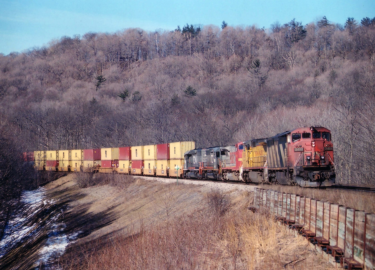 I concentrated around Dundas' Mile 2 in the spring of 2007 on account the CN had just done some major work in shoring up the trackbed here; and I wanted to get my fill of what I thought was a great curve while it was still possible. Nice and open. A few short years and Ma Nature filled this in to the point that now, in the summer, it looks like a jungle. Maybe it is just my preference; virtually no one else bothered to shoot here. This was a nice collection of power. Too bad CN grabbed a page out of the CP Handbook and put a grubby leader on it. CN 2411 leading UP 9439. BNSF 548, WC 6910 and 6925 with train #384, Flat Rock MI to Mac Yard.