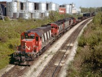 Back when there were trains to see I used this Portage Rd bridge vantage point rather often. I cannot quite make out whether that white marker to the right of the last unit is the MILE 3 marker for the Grimsby sub., but that would be about right. All those big tin cans in the background are part of the Chateau-Gai Wine empire that used to be in business there. I don't know what happened with them, but one day I went by...everything was gone and some outfit was storing lumber on the property. So that, along with all the interesting power on this westbound train, is now history. Two MLW sandwiched by GMD. SD40, a C424, an M-636 and GP9 on the rear. The GP soldiers on as CN 7032:2 according to CTG. The others all off the roster. Power consist is CN 5081, 3216, 2339 and 4533. Barely visible in the background is the corner of Whirlpool and Stanley Av.