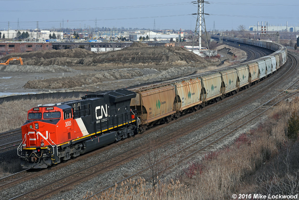 CN 3005 brings up th markers on the rear of train 730, 151 potash loads and three units. Am pleased to have caught one of these monsters at the old Lasco bridge in the few remaining weeks before it is closed for good. 1331hrs.