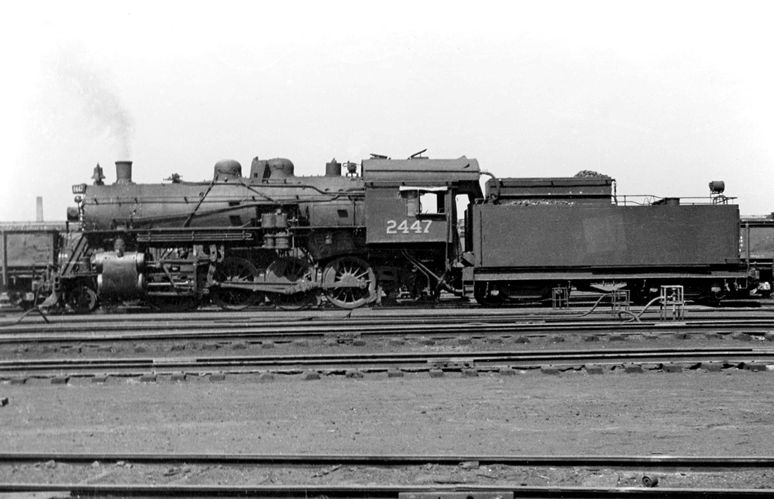 Canadian National N-1-C class 2-8-0 2447 (built by Canada Foundry in 1917, originally of Canadian Northern lineage) sits at Mimico in 1954. Diesel locomotives had been making inroads into Canadian railroading for a number of years (GMD was now building brand new FP9's and GP9's when this photo was taken), but regular steam service still hung on a few years more before the last fires were put out. 2447 herself only had a little under 3 years left, being scrapped in July of 1957 at age 40.