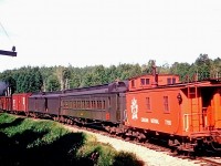CN Train M264 which set out from Parry Sound almost four hours ago on its day long journey to Algonquin Park is seen on 10 August, 1953 a few minutes west of Scotia.  Running eastbound on Mondays and Fridays, and westbound a day later, the train took 10 hours for the 94.6 mile journey including a three hour layover at Scotia making connections with north and southbound Toronto - North Bay trains.  Originally part of lumber baron J. R. Booth’s busy Ottawa, Arnprior & Parry Sound Railway, traffic diminished over the years and the Parry Sound to Scotia segment was closed not long after the photo was taken, on the promise that the communities would be linked by a provincially built paved road.
<br><br>
<i>[General location geotagged, not exact]</i>