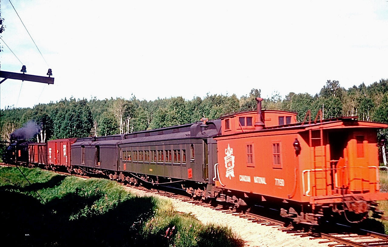 CN Train M264 which set out from Parry Sound almost four hours ago on its day long journey to Algonquin Park is seen on 10 August, 1953 a few minutes west of Scotia.  Running eastbound on Mondays and Fridays, and westbound a day later, the train took 10 hours for the 94.6 mile journey including a three hour layover at Scotia making connections with north and southbound Toronto - North Bay trains.  Originally part of lumber baron J. R. Booth’s busy Ottawa, Arnprior & Parry Sound Railway, traffic diminished over the years and the Parry Sound to Scotia segment was closed not long after the photo was taken, on the promise that the communities would be linked by a provincially built paved road.

[General location geotagged, not exact]