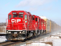 CP 3033, CP 2263 and CP 3033 charge West towards Wolverton with 39 autoracks from Toyota in Cambridge