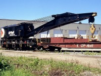 CP Rail "Big Hook" 414501, a 250-ton Industrial Brownhoist wrecking crane built in 1946 (originally steam powered, converted to diesel), sits at the Canadian Railway Museum (Exporail) with its boom car 412333.
<br><br>
Before the days of on-demand cleanup contractors like Hulcher and their fleets of side-boom Cat tractors, railways maintained their own wreck auxiliary trains at major divisions, that included a crane or two. Unlike the common small diesel-powered cranes commonly used for maintenance of way and track duties, wrecking cranes were intended for lifting and clearing heavy steam and later diesel locomotives to get the railway's line open again. Crane sizes varied: steam-powered-100 ton cranes built in the 1910/1920's were once common at smaller points during the steam era, and CP also rostered nearly a dozen large 200-ton cranes, but major terminals like Toronto would often warrant the biggest of the big: the 250-ton crane, of which CP owned about half a dozen in the 414500/414600 series.
<br><br>
Over time as contracting services became more popular, railways eliminated their auxiliaries and disposed of (scrapped) their large wrecking cranes, although CP does still maintain some out west in places like Golden and Revelstoke.
<br><br>
Based out of Toronto and the eastern region for much of its life, 414501 was put up for sale by CP in 2000, and acquired by Exporail in 2002.
