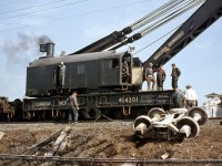 Another photo of Canadian Pacific "Big Hook" 414501 (an Industrial Brownhoist 250 ton wrecking crane, at time of this photo still steam powered!) working at a wreck at Dixie on the CP's Galt Subdivision in 1959. It was quite pile up of cars (no locos) mainly from the Kitchener/Waterloo and Galt areas, including beer and whiskey in box cars (from Seagrams & Carlings in Waterloo) and a lot of limestone from covered hoppers. What was unusual was the lack of security - just one railway policeman in uniform. When I approached to take photos he came up to me and said be careful, also do not take any booze. Note workers on crane - very casual, no hard hats, etc. A diferent era compared to today.
<br><br>
CP 414501 after retirement at Exporail: <a href=http://www.railpictures.ca/?attachment_id=23098><b>http://www.railpictures.ca/?attachment_id=23098</b></a>