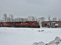 CP 9101 and CP 9141 idle in front of the old station in MacTier awaiting the arrival of CP 9627 south on a snowy Family Day.