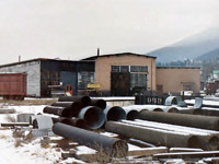 The weather had closed in & it was snowing lightly, but that did not stop me. So I took what little free time I had while in Nelson & after parking on the airport side of the property I walked over to the old roundhouse area. The steam locomotive stalls were long gone, but the back shop area of the building was still there, as was the turntable. The lights were on in the building, but I have no idea what it was being used for. Sadly all is now long gone!