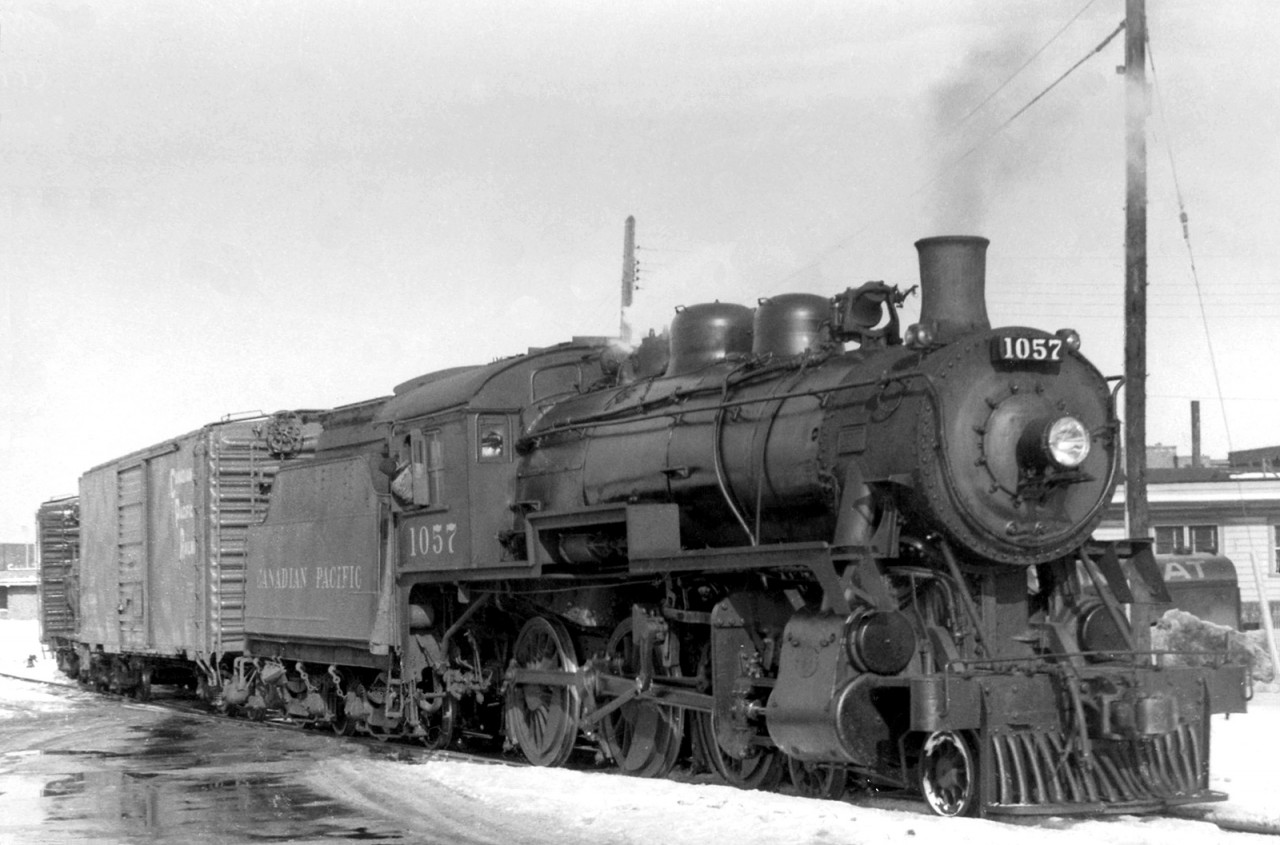 Well-known Canadian Pacific D10g 4-6-0 1057 is pictured working in regular freight service at Owen Sound in 1957, during its career as just another one of CP's numerous D10's. The D10-class of steam engines were popular "do-everything" locomotives often used in branchline, local, mainline, and passenger duties all across the CP system, like an SW1200RS or GP9 would be in the diesel era.

1057 would go on to operate on the famed "tripleheader" excursion on May 1st 1960, and work in fantrip and excursion service for the next few decades before going to its present home in Tottenham.
Working a fantrip at Campbellville with 136: http://www.railpictures.ca/?attachment_id=14939