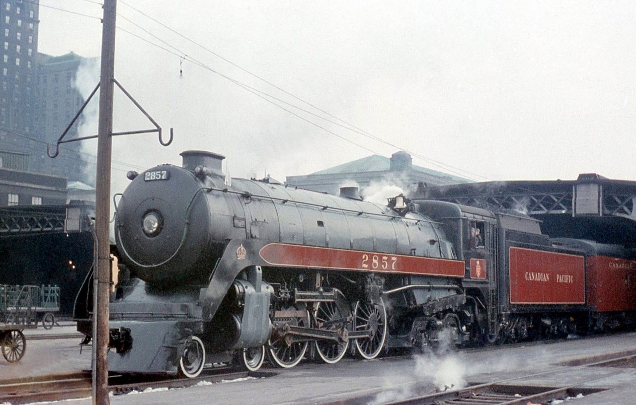 Canadian Pacific Royal Hudson 2857 poses with her train sticking out of the train shed of Toronto's Union Station on March 27th 1960. 2857 was running a fantrip departing from Toronto to Port McNicoll, and back. Notable on the trip was visiting what turned out to be the last bastion of regularly assigned freight steam engines at Port McNicoll, including 3632 and 3722.