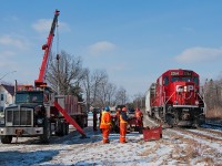 A special transformer move arrives at Myrtle where crews from Don Anderson Haulage and Ontario Hydro will begin to set up. The move will take this transformer load off it's center depressed flat car onto a heavy duty center depressed tractor trailer for further delivery to a substation up street. 