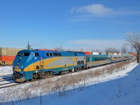<b>Class leader past a wall of stacks.</b> Class leader VIA 900 leads VIA 55 on CN's Kingston sub past CP 112 with mostly double stack cars on the parallel CP Vaudreuil sub at Dorval.