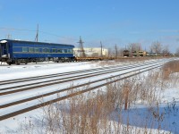 <b>Bringing up the rear of a military move.</b> CP 142 had a cut of militiary equipment at the rear today, with 15 flat cars holding military equipment, 3 empty flat cars and the private ex-CN car <i>Tioga Pass</i> at the very end.