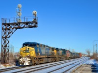 <b>Differences in AC4400CW's.</b> CN 327 is through Dorval on a gorgeous afternoon with a pair of CSXT AC4400CW's (CSXT 531 & CSXT 106) along with GP9 CN 4102. The leading unit is newer (built in 2001) but has the older YN2 paint scheme, while the older trailer (built in 1995) has the newer YN3 paint scheme. Another difference is the steerable trucks on the leader, versus the hi-adhesion trucks on the trailer.