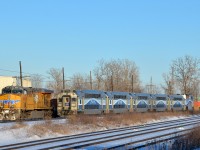 <b>Union Pacific leading an AMT commuter train?</b> No, not quite, but it kind of looks like that as AMT 19 with cab car AMT 3008 leading passes CP 143, stopped with UP 5550 leading. CP 143 will depart shortly and follow AMT 19 westwards along CP's Vaudreuil Sub.