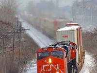<b>CN 149 around the curve.</b> Hot shot Montreal-Chicago intermodal train CN 149 blasts through Beaconsfield with ES44AC's CN 2924 & 2889 as power.