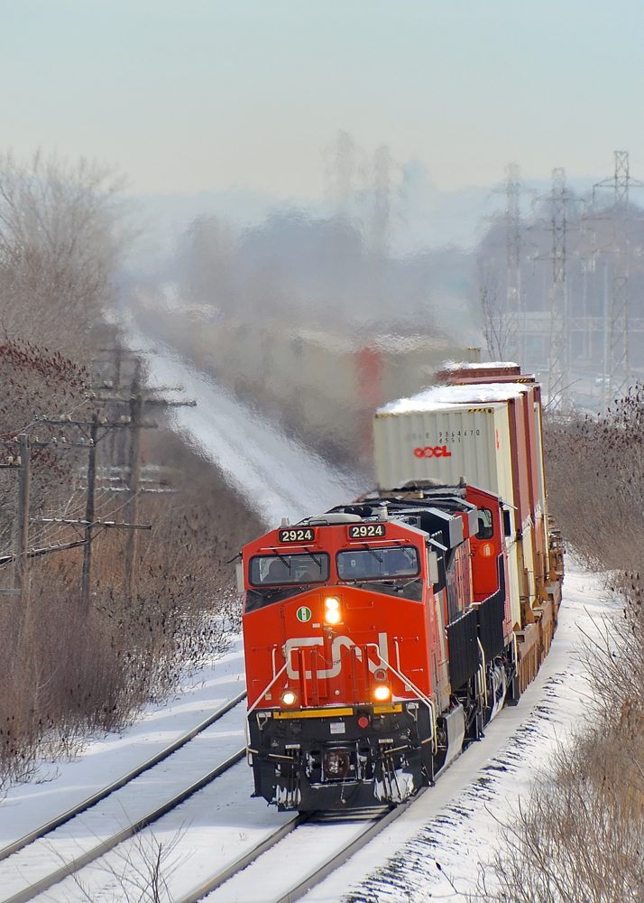 CN 149 around the curve. Hot shot Montreal-Chicago intermodal train CN 149 blasts through Beaconsfield with ES44AC's CN 2924 & 2889 as power.