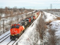 <b>Intermodal hot shot.</b> Hot shot Montreal-Chicago intermodal train CN 149 blasts through Beaconsfield with ES44AC's CN 2924 & 2889 as power.