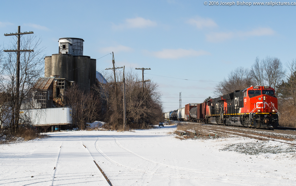 CN 3028 leads train X332 through Copetown Ontario and past the old feedmill on a sunny January morning.