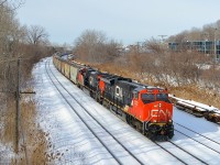 <b>Potash train approaching a crew change.</b> Running for the first time, CN B730 has 153 potash loads from Yarbo, Saskatchewan destined for Saint John, New Brunswick as it slowly approaches Turcot West where it will get a new crew to bring it to Joffre Yard. Power is a trio of GEVO's, with ET44AC CN 3032 leading ES44AC's CN 2925 trailing and CN 2879 at the end of the train.