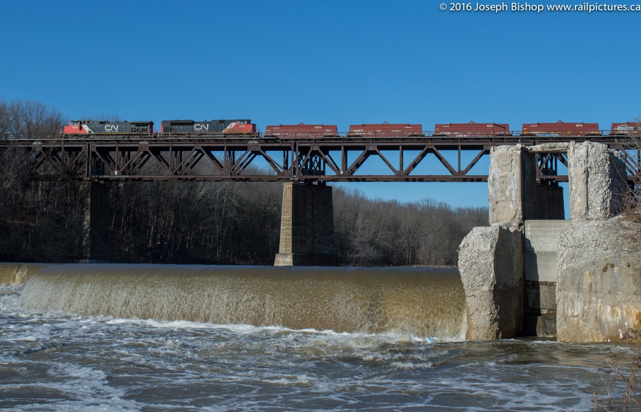 CN 331 crosses the Grand River bridge in Paris viewed from below the dam.  It was a very odd February day, the temperature on my car's dashboard said +14 as we headed towards Paris on Paris Road.  Having been stuck in lectures all morning a walk was in order, I figured that the sun was out and it was worth a shot to get over to Paris and try for 331 as well as making someone happy...it worked!