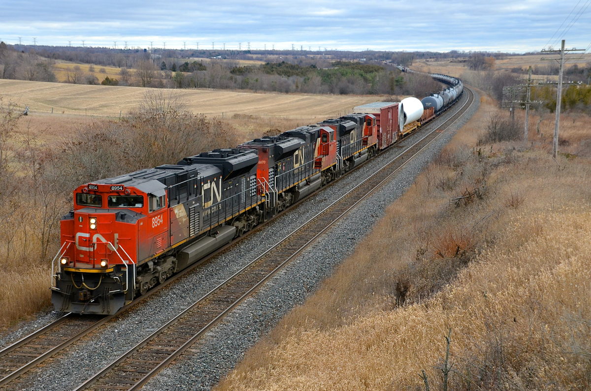 Triple SD70M-2's. A trio of SD70M-2's (CN 8954, CN 8870 & CN 8016) negotiate the s-curve at Newtonville on an overcast day. Operating mid-train is CN 2693.