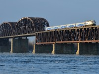<b>A matched AMT consist crossing the river.</b> The stripes on the rear of F59PH AMT 1341 match the consist of 5 Comet cars which are trailing, all of which were repainted and refurbished a few years back. This is AMT 84, crossing the St-Lawrence river in the morning sun, just a couple of minutes from its first stop on the island of Montreal at Lasalle station.