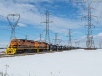 RLHH 595 slowly throttles up out of Garnet with RLHH 3404 and RLHH 3049.  They are approaching the Highway 3 road crossing during a brief period of sun on a mainly cloudy Tuesday.