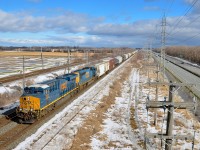 <b>A fairly new ES44AH leading.</b> A short CN 327 has just crossed over from the north to the south track of CN's Kingston sub in Sainte-Anne-de-Bellevue, at the western tip of the island of Montreal. Power is a fairly new ES44AH (CSXT 3181) & SD70MAC 4791.