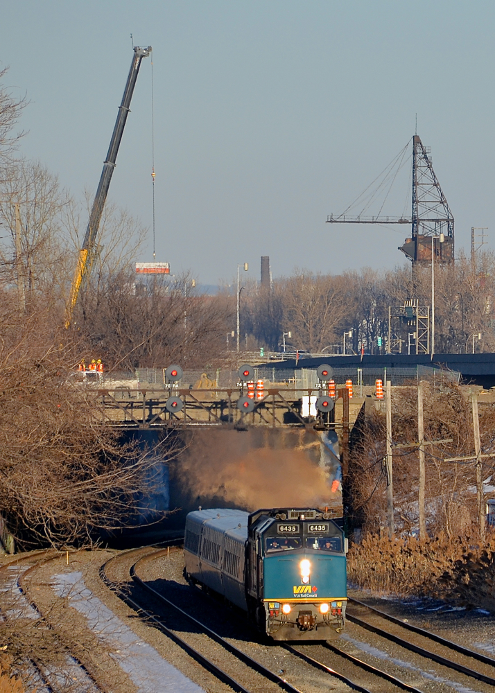 A scene that will soon change. As evidenced by the crane at the left in this photo, a lot of infrastructure work is going on in Montreal West near CN's Montreal sub. The short tunnel that VIA 67 is exiting will soon be demolished and I am unsure if the signal bridge will remain. Here VIA 67 led by VIA 6435 passes venerable signals with three LRC cars trailing.