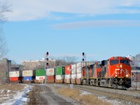 <b>The head end of a very long stack train.</b> A very long CN 120 (660 axles, 13,793 feet) is rounding a curve in Montreal with CN 2938, CN 2544 & CN 2693 at the head end. Operating mid-train is CN 3028.