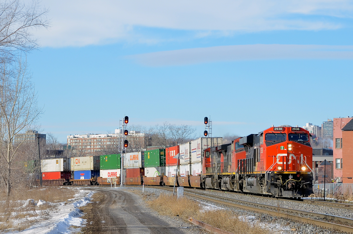 The head end of a very long stack train. A very long CN 120 (660 axles, 13,793 feet) is rounding a curve in Montreal with CN 2938, CN 2544 & CN 2693 at the head end. Operating mid-train is CN 3028.