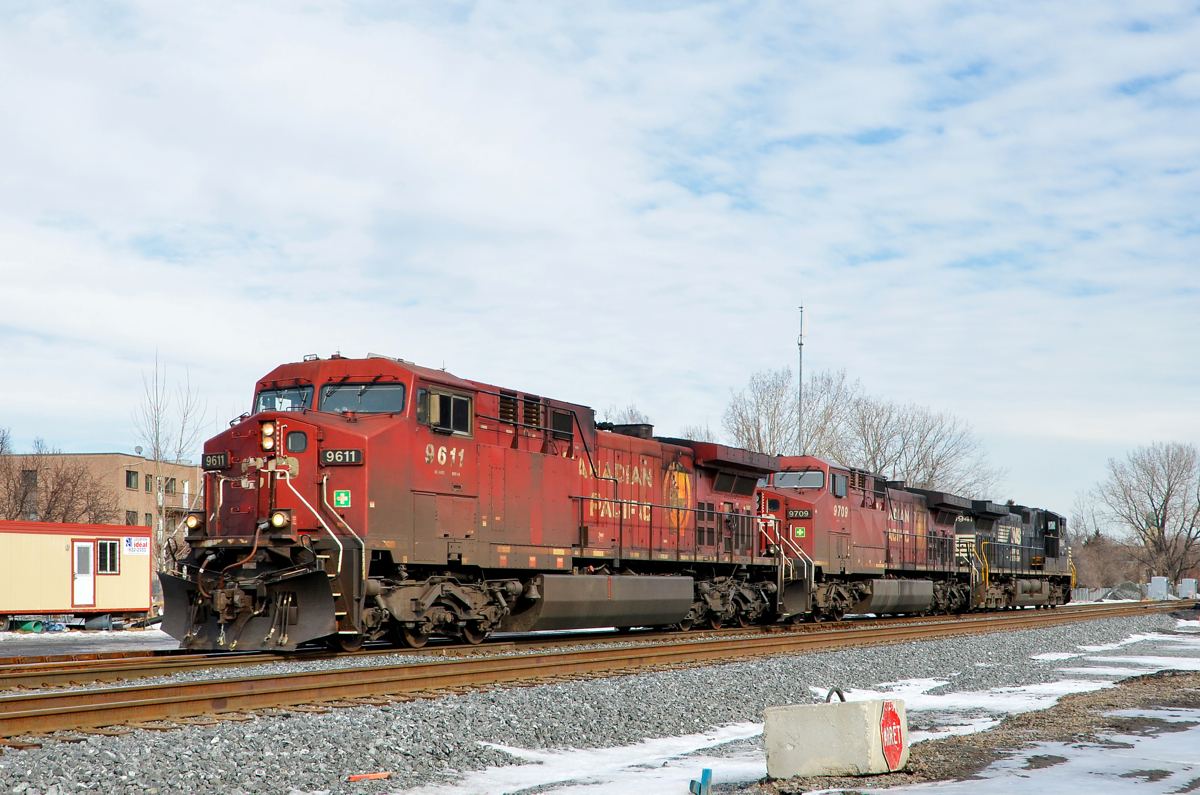 CP & NS power, light on CN. CN 529 has no cars as it heads west through St-Henri, with CP 9611, CP 9709 & NS 9941 for power.