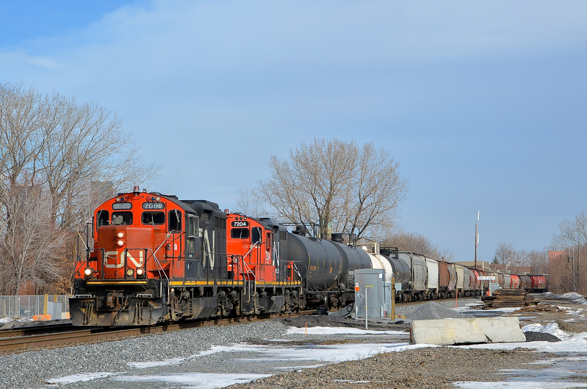 A pair of GP9's elephant style. GP9's CN 7062 & CN 7204 are arranged elephant style as they lead transfer CN 500 towards Taschereau Yard with 35 cars.