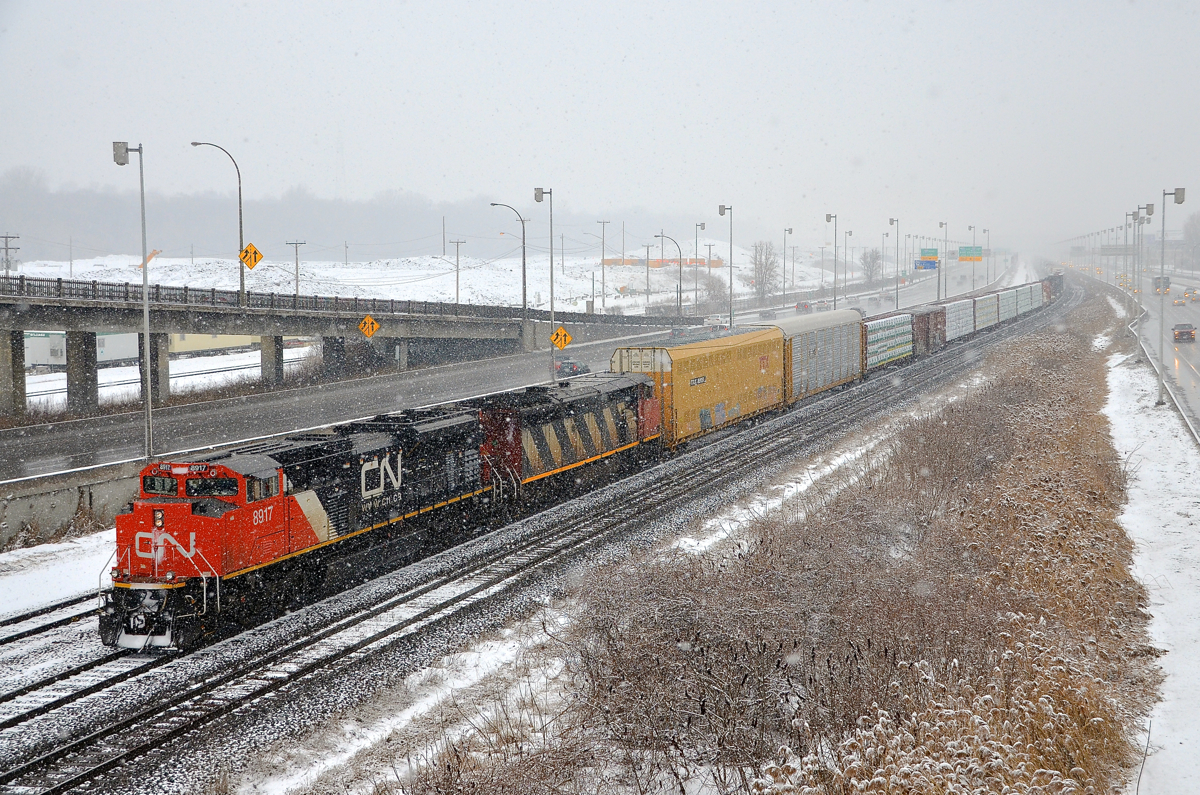 Thick snow falling. CN 401 has CN 8917 & CN 2407 for power and 104 cars as it approaches Turcot West in Montreal on a snowy afternoon.