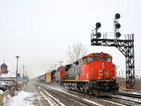 <b>Dorval Dash9 duo with a difference.</b> CN 368 has a pair of Dash9's (CN 2516 & CN 2595) arranged elephant style as it speeds by VIA's Dorval Station. The lead unit is a Dash9-44CWL with its distinctive 4-piece windshield while the trailing unit is a more conventional Dash9-44CW.
