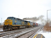 <b>A repainted GE smoking it up.</b> Recently repainted AC4400CW CSXT 409 smokes it up as CN 327 starts to accelerate after waiting for CN 368 to pass on the north track. Trailing are non-repainted AC4400CW CSXT 53 and ET44AC CN 3031.