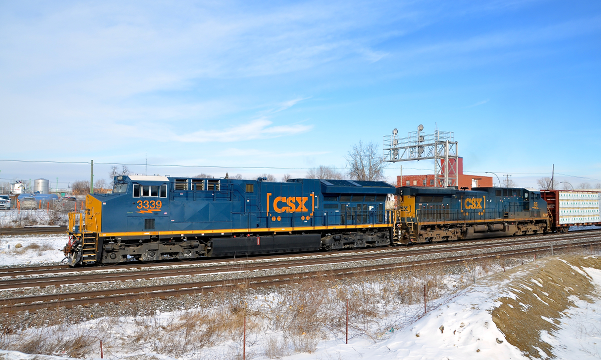 Brand new and older GE's in matching paint schemes. Nearly brand new ET44AC CSXT 3339 leads CN 327 through Dorval after waiting for VIA 50 to pass on the north track. Trailing is an older GE, AC4400CW CSXT 83, which has been repainted in the same current paint scheme that 3339 wears.