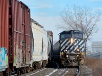 <b>CN 368 and CN 377 around a curve.</b> CN 377 heads around a curve in Dorval with BCOL 4650 leading on the south track of CN's Montreal Sub, as CN 368 heads east on the north track. <i><b>Note</b></i>: shot with a telephoto lens from the VIA Rail station platform