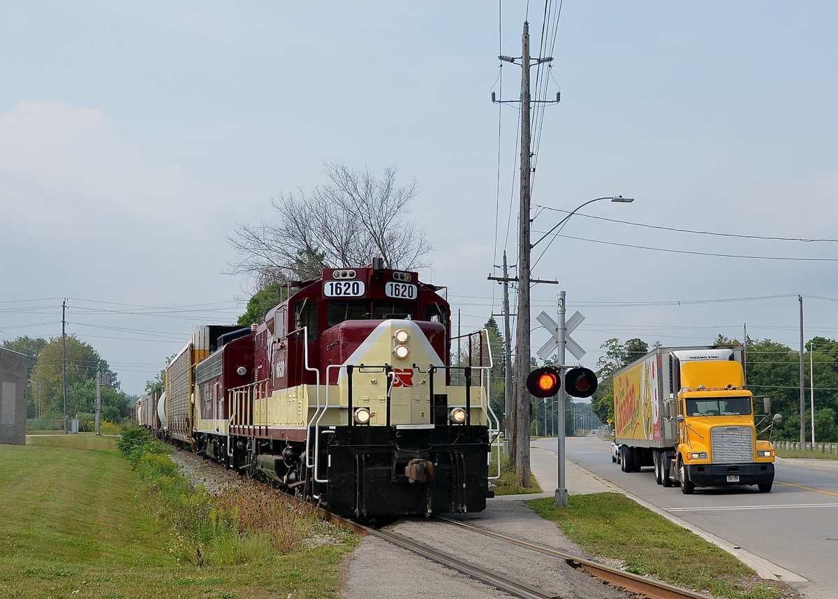 Crossing over a sidewalk. After picking up cars in Putnam and Ingersoll, GP9 OSRX 1620 and FP9A OSRX 6508 head to Woodstock.