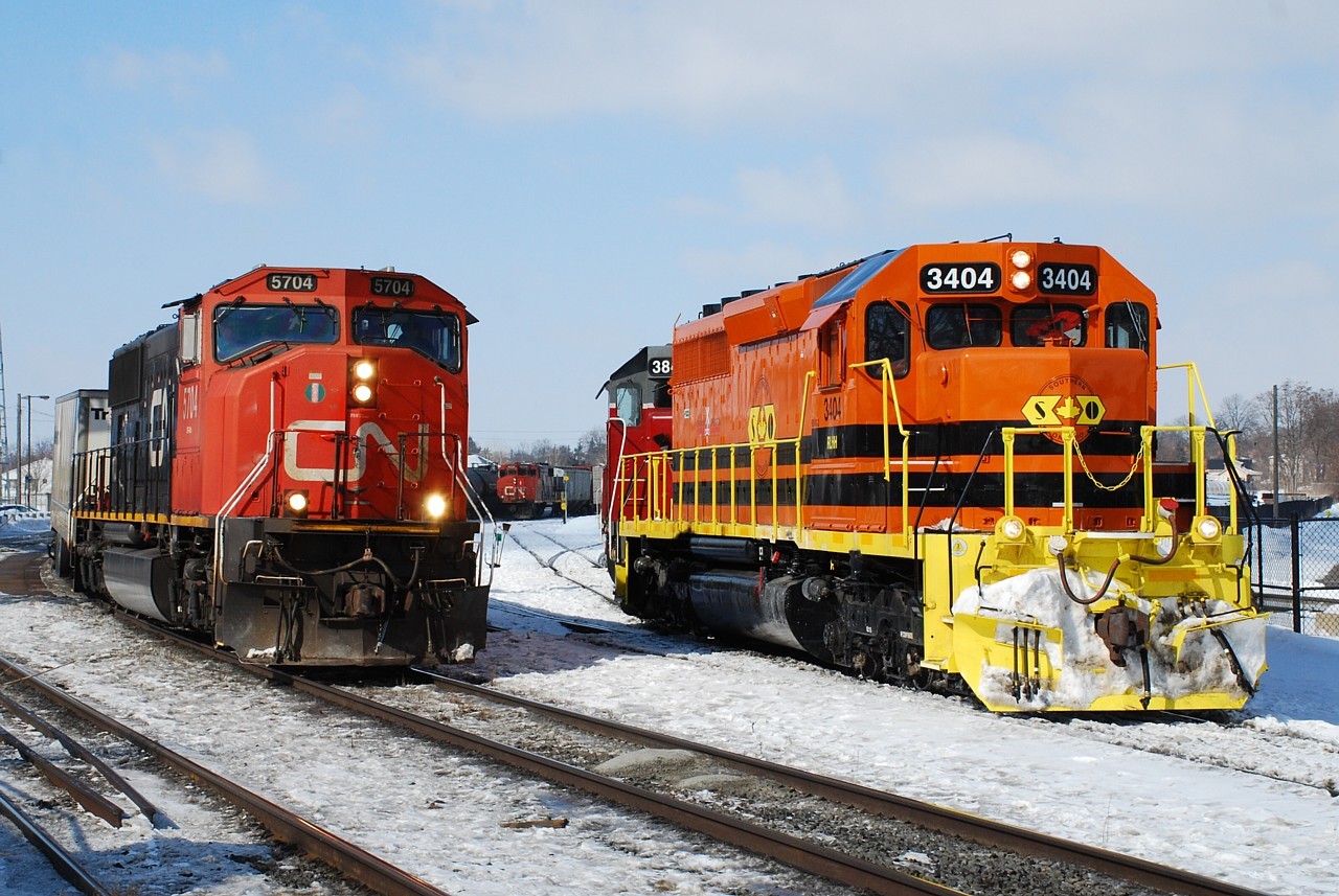 The waiting game.  A late-running RLHH 595 is only getting later while they wait in the clear for CN 144 to pass.  Poor 580 is trapped in the yard, waiting for RLHH 595 to finish putting their train together and depart the yard so they too can head out to Normerica to start their work for the day.