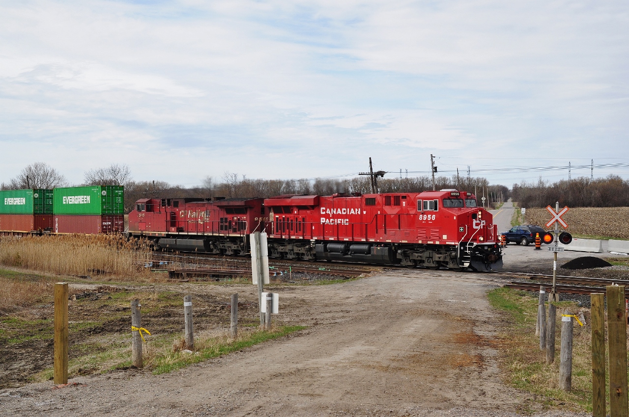 (Another) pair of GE's power an eastbound CP at Lovekin, Ontario. 
 

Even as recently as 2012 the Stephenson / Lakeshore Road crossing had a rural look ! (today the road is paved).
 

Image by S.Danko
 

Same location, twenty-eight years earlier: 
 

  MLW heavies  
 

sdfourty
