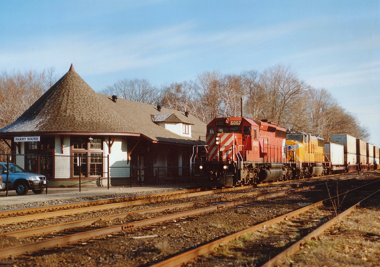 Rather frosty but sunny morning in late April as CP 6062 and UP 4058 are Toronto-bound with a stack train. The newly restored CP station is now a gift shop and art gallery and certainly has a lot of eye appeal. Great restoration job!! Southbound trains along this track now are a rarity; as directional running thru is area has trains northbound on this CP track while the CN track thru town is used for southbounds.