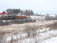 GEXR train 431 is seen kicking up fresh snow as it passes Venture Heights farm just east of Guelph.