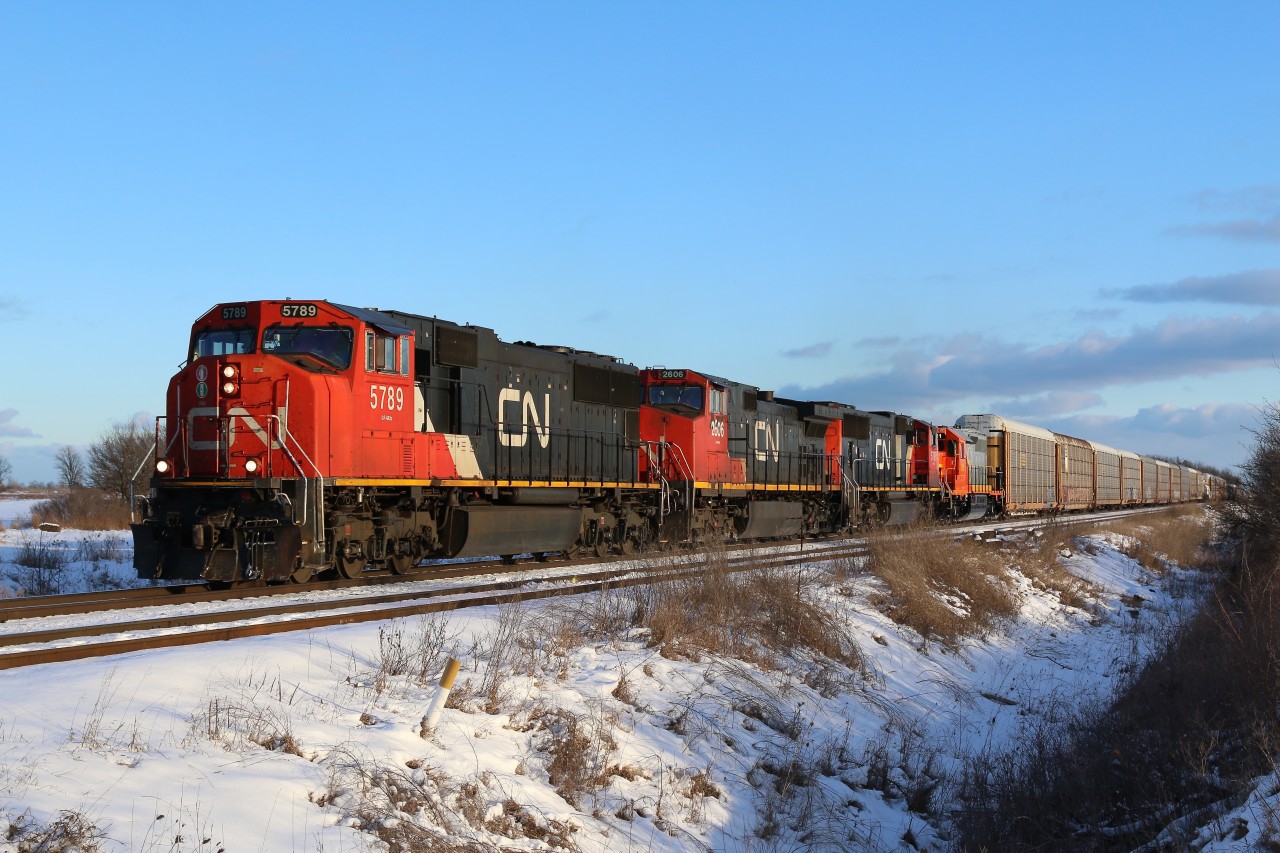 CN train 148 has found its way out of the clouds just in time as it heads through Tansley just south of Milton. Fourth unit back is freshly rebuilt and repainted Quebec, North shore & labrador SD40 #311returning home.