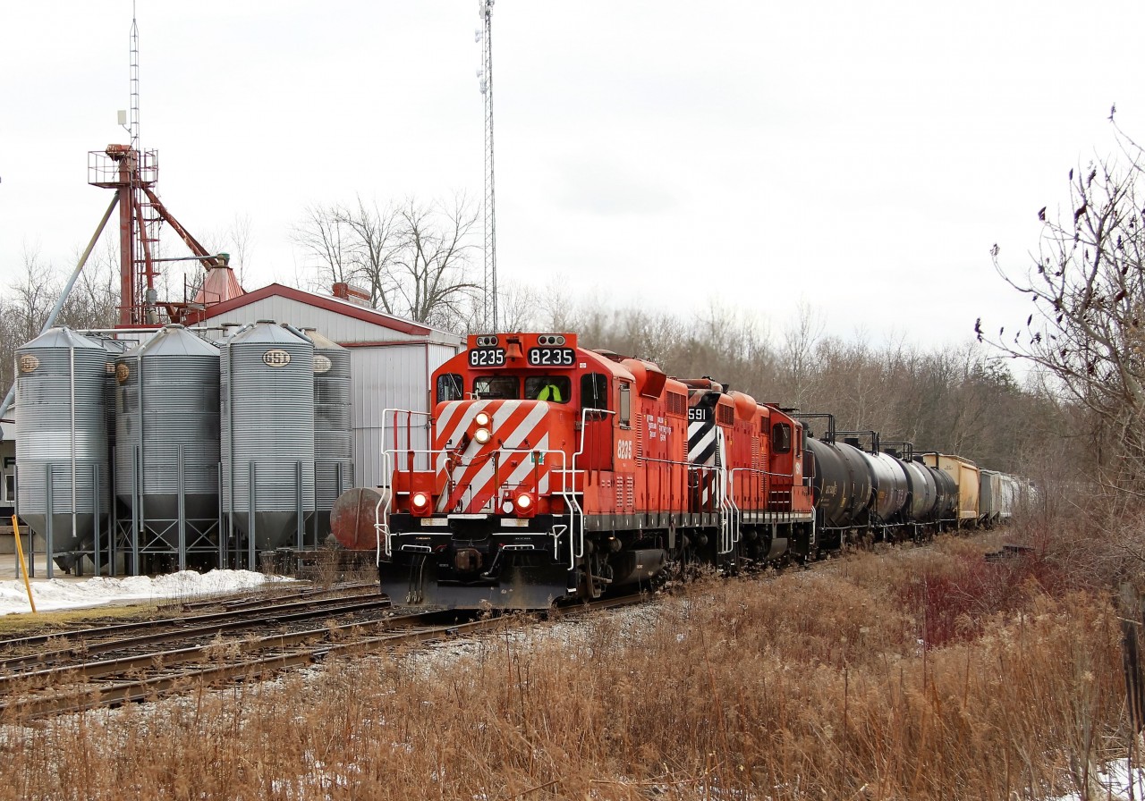After doing the switching at Guelph Junction, OSR 8235 leads OSR 1591 in to the village of Moffat and past Sharpe Farm Supply on their way back to Guelph. OSRX 434462 was tagging up the rear once again.