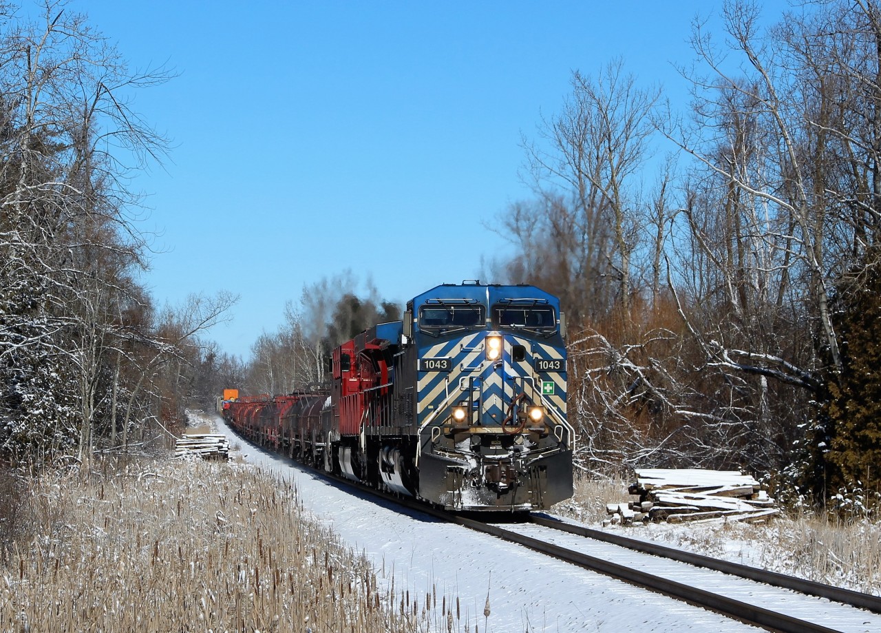After waiting for CP 9805 to exit the Hamilton sub and go west bound, CEFX 1043 leads CP 8938 down the Hamilton sub up to the Carlisle Road crossing at MM 71.21 on a cold but sunny morning.